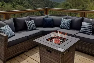 fire pit on deck of cabin with mountain view