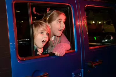 kids looking out the side of a jeep