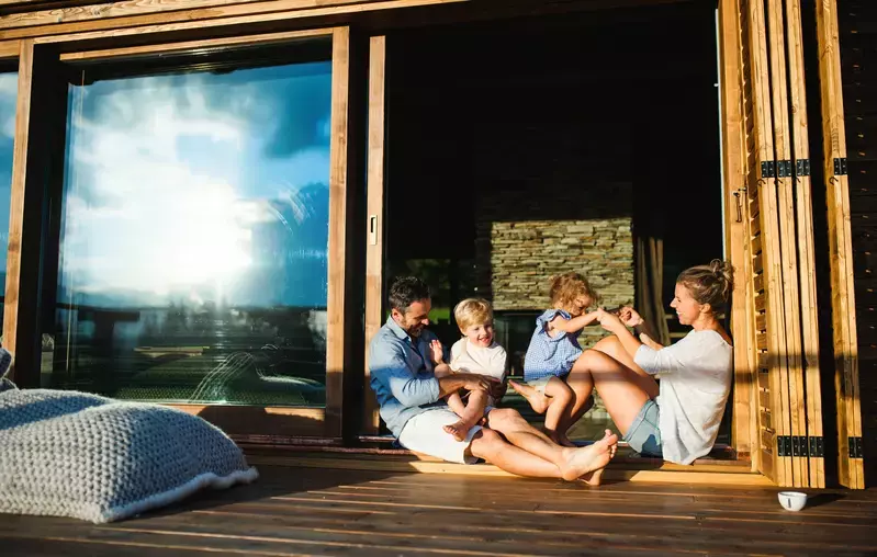 family sitting in doorway of Smoky Mountain cabin rental