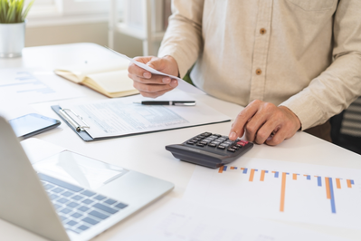 businessman with calculator and laptop