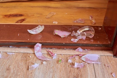 broken dish on floor of cabin