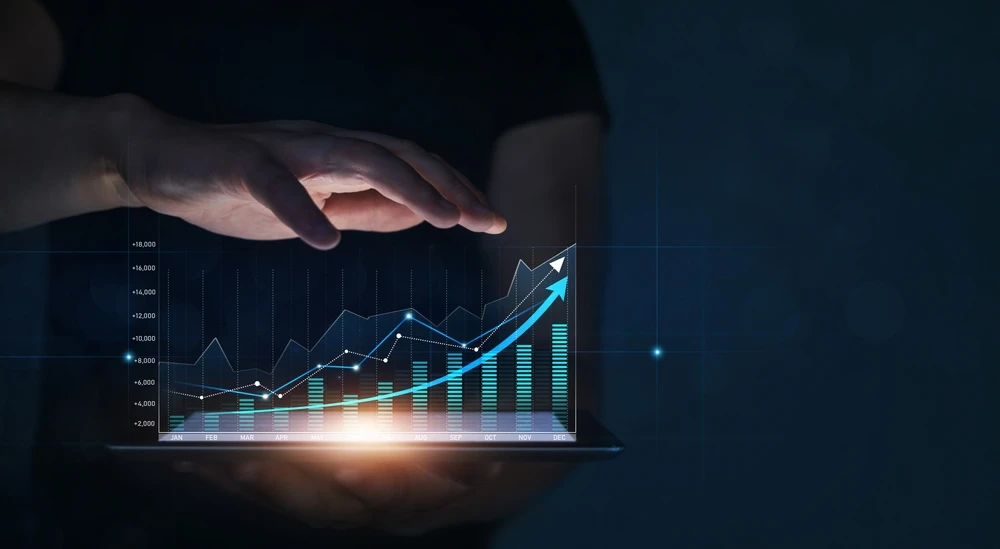 man holding a graph showing a revenue projection
