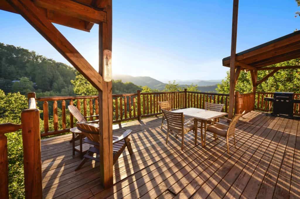 deck of a gatlinburg cabin with furniture and grill
