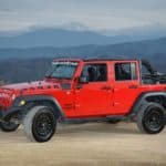 red jeep in front of the mountains