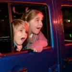 kids looking out the side of a jeep