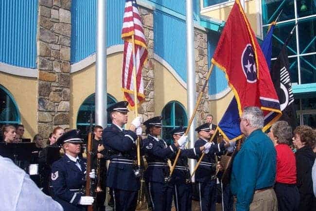 ceremony with people in uniforms holding flags