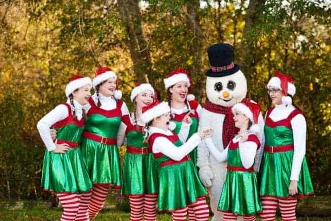 girls dressed as elves with snowman