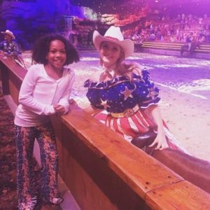 girl posing with cast member dolly's stampede