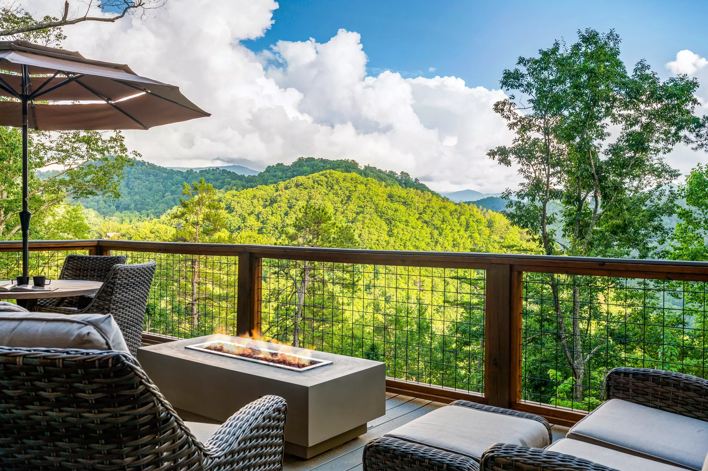 looking out at mountain view from cabin porch with fire pit